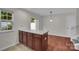 Eat-in kitchen with tiled floors, wooden island, and view to outdoor patio at 5237 Ficus Tree Ln, Charlotte, NC 28215