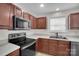 Functional kitchen featuring stainless steel appliances, wood cabinets, and white countertops at 5237 Ficus Tree Ln, Charlotte, NC 28215
