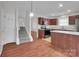 Open concept kitchen featuring dark wood cabinets and stainless steel appliances at 5237 Ficus Tree Ln, Charlotte, NC 28215