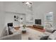Bright living room with fireplace, high ceilings, and an open view to the staircase at 5237 Ficus Tree Ln, Charlotte, NC 28215
