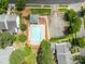 A birds eye view shows a rectangular community pool surrounded by lounge chairs and lush landscaping at 5305 Waverly Lynn Ln # 4A, Charlotte, NC 28269