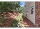 Side yard features a natural drainage area, landscaping, and vinyl siding at 5305 Waverly Lynn Ln # 4A, Charlotte, NC 28269