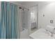 Bathroom featuring a shower with a bathtub and an additional sink area beyond the doorway at 5305 Waverly Lynn Ln # 4A, Charlotte, NC 28269