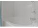 Clean, tiled bathtub with chrome faucet and shower handle, bathed in bright, white light at 5305 Waverly Lynn Ln # 4A, Charlotte, NC 28269