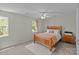 Bedroom showcasing a bed, windows, a ceiling fan and two nightstands with lamps for cozy living at 5305 Waverly Lynn Ln # 4A, Charlotte, NC 28269