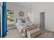 Bright bedroom with a floral comforter, windows, and nautical-themed clock create a charming space at 5305 Waverly Lynn Ln # 4A, Charlotte, NC 28269
