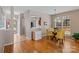Bright dining area featuring hardwood floors, a glass-top table, and yellow chairs at 5305 Waverly Lynn Ln # 4A, Charlotte, NC 28269