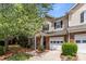 Charming townhome featuring a brick facade, attached garage, and well-manicured front yard at 5305 Waverly Lynn Ln # 4A, Charlotte, NC 28269