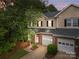 Charming townhome featuring a brick facade, attached garage, and well-manicured front yard at 5305 Waverly Lynn Ln # 4A, Charlotte, NC 28269