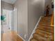 Hallway with wooden staircase and access to multiple rooms at 5305 Waverly Lynn Ln # 4A, Charlotte, NC 28269
