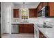 Well-lit kitchen with stainless steel appliances, brown cabinets, and white countertops at 5305 Waverly Lynn Ln # 4A, Charlotte, NC 28269