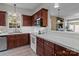 Well-lit kitchen with wood cabinets, white countertops, and modern appliances at 5305 Waverly Lynn Ln # 4A, Charlotte, NC 28269