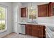 Well-lit kitchen with stainless steel appliances, brown cabinets, and white countertops at 5305 Waverly Lynn Ln # 4A, Charlotte, NC 28269