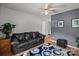 Comfortable living room with a dark sofa, neutral walls, and a ceiling fan offers a relaxing and inviting space at 5305 Waverly Lynn Ln # 4A, Charlotte, NC 28269