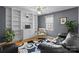 Stylish living room features custom bookshelves, comfortable seating, and abundant natural light for a cozy and inviting space at 5305 Waverly Lynn Ln # 4A, Charlotte, NC 28269