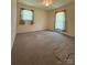 Bedroom with neutral carpet and two windows at 5420 Harkey Rd, Waxhaw, NC 28173