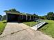 Accessible brick home features ramp, carport, and well maintained front lawn at 5420 Harkey Rd, Waxhaw, NC 28173
