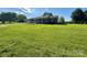 Charming brick home featuring a well maintained lawn and a convenient access ramp at 5420 Harkey Rd, Waxhaw, NC 28173