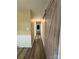 Hallway with wood-look flooring and decorative sliding door at 5420 Harkey Rd, Waxhaw, NC 28173