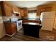 Traditional kitchen with wood cabinets, tile backsplash, and island at 5420 Harkey Rd, Waxhaw, NC 28173