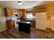 Well-equipped kitchen with wood cabinets, modern appliances, and a functional kitchen island at 5420 Harkey Rd, Waxhaw, NC 28173