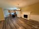 Inviting kitchen area featuring wood cabinets, modern appliances, and a decorative fireplace at 5420 Harkey Rd, Waxhaw, NC 28173