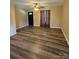 Bright living room with a black front door, stylish curtains, and modern flooring at 5420 Harkey Rd, Waxhaw, NC 28173
