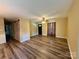 Spacious living room showcasing modern wood floors, ceiling fan, and stylish fixtures at 5420 Harkey Rd, Waxhaw, NC 28173