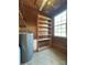 The utility room features a water heater, wooden shelving, and a window for natural light at 5420 Harkey Rd, Waxhaw, NC 28173