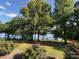Lush trees and shrubs provide privacy while enjoying the view of the adjacent water at 5420 Harkey Rd, Waxhaw, NC 28173