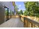 A wooden back deck with railings offering a nice outdoor space at 550 W Cama St, Charlotte, NC 28217