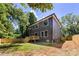 A modern two-story home with a wooden deck and lush lawn, perfect for outdoor enjoyment at 550 W Cama St, Charlotte, NC 28217