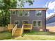 A large, two-story home featuring a wooden deck and well-manicured lawn at 550 W Cama St, Charlotte, NC 28217
