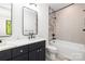 Modern bathroom featuring double vanity with marble countertop and a tiled shower/tub at 550 W Cama St, Charlotte, NC 28217