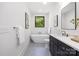 Luxurious bathroom featuring a soaking tub, sleek vanity, and modern fixtures at 550 W Cama St, Charlotte, NC 28217