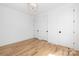 Spacious bedroom with hardwood floors, white walls and trim, and recessed lighting at 550 W Cama St, Charlotte, NC 28217
