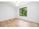 Bright bedroom with hardwood floors and natural light from the large window at 550 W Cama St, Charlotte, NC 28217