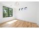 Bright bedroom with hardwood floors and a large window at 550 W Cama St, Charlotte, NC 28217