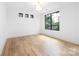 Bedroom with hardwood floors, white walls and modern light fixture at 550 W Cama St, Charlotte, NC 28217