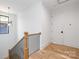 Bright hallway with hardwood floors, modern railing and fixtures, and white walls at 550 W Cama St, Charlotte, NC 28217
