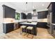 Modern kitchen with stainless steel appliances, marble island, and dark cabinetry at 550 W Cama St, Charlotte, NC 28217