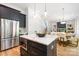 Gourmet kitchen with stainless appliances and a large island that flows into the living room at 550 W Cama St, Charlotte, NC 28217