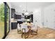 Bright kitchen dining area with modern lighting, cabinetry, and access to the outdoors at 550 W Cama St, Charlotte, NC 28217