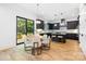Open-concept kitchen with dark cabinetry, modern appliances, and hardwood flooring at 550 W Cama St, Charlotte, NC 28217