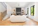 Bright and airy living room with fireplace, staircase, and contemporary design at 550 W Cama St, Charlotte, NC 28217