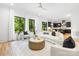 Bright, open-concept living room with large windows and modern furnishings flows into kitchen at 550 W Cama St, Charlotte, NC 28217