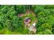 Aerial view showcasing the home nestled within lush greenery and surrounded by trees at 6350 Mount Pleasant S Rd, Concord, NC 28025