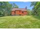 Exterior rear view of the home with a spacious lawn and wooden deck at 6350 Mount Pleasant S Rd, Concord, NC 28025