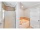 Bright bathroom with a bathtub and a glass-enclosed shower at 6350 Mount Pleasant S Rd, Concord, NC 28025