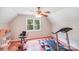 Bright bonus room with an exercise machine and dollhouse at 6350 Mount Pleasant S Rd, Concord, NC 28025